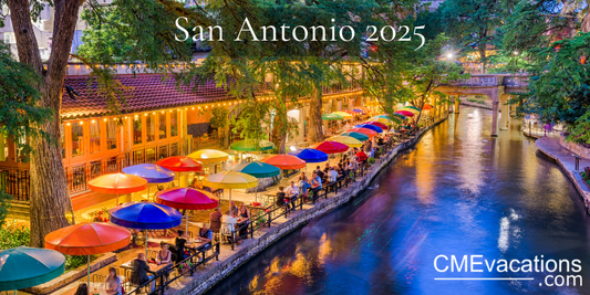 Evening view of a canal with colorful umbrellas and people in San Antonio, 2025.